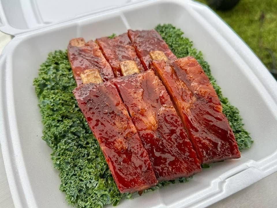 Sliced cured meat on kale